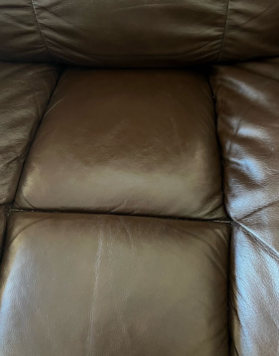 Brown leather seat restored after surface damage and wear